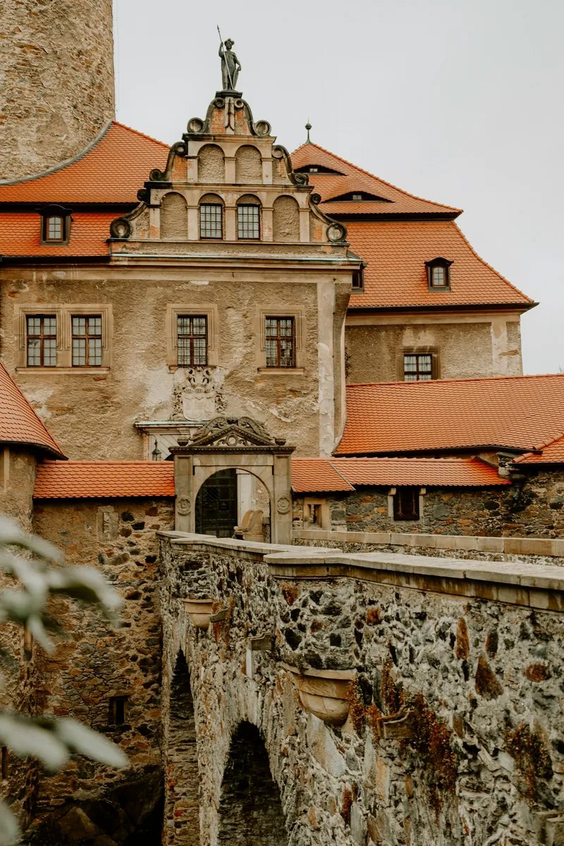 Czocha Castle (Zamek Czocha) on its gneiss rock above Lake Leśnia in Lower Silesia, Poland — a fairytale medieval fortress rebuilt in the 1910s, famed for its film roles and the College of Wizardry live-action role-play.